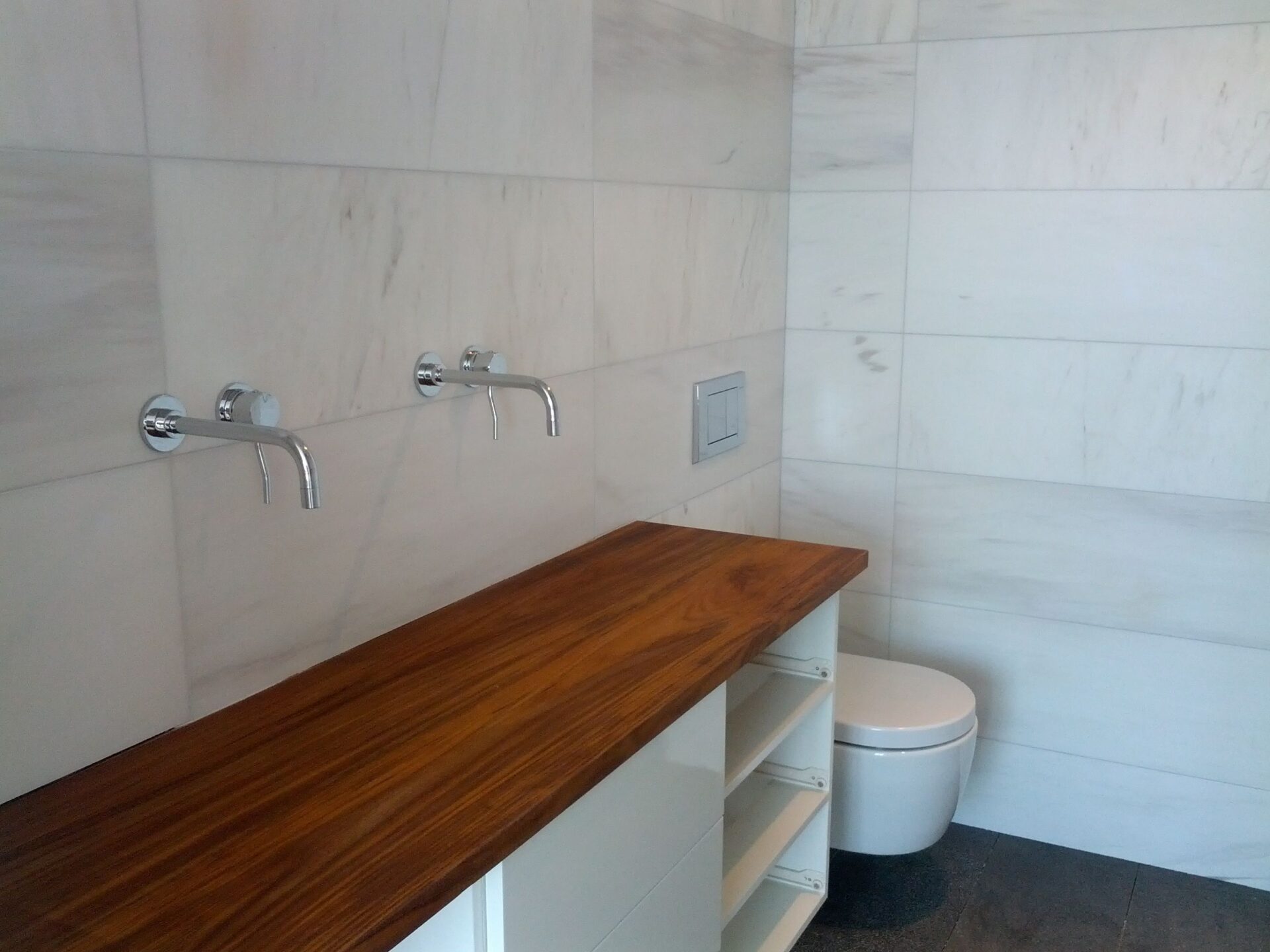 teak, teak counter, wall mount facets, two facets, wall mounted toilet, white toilet, large tiles