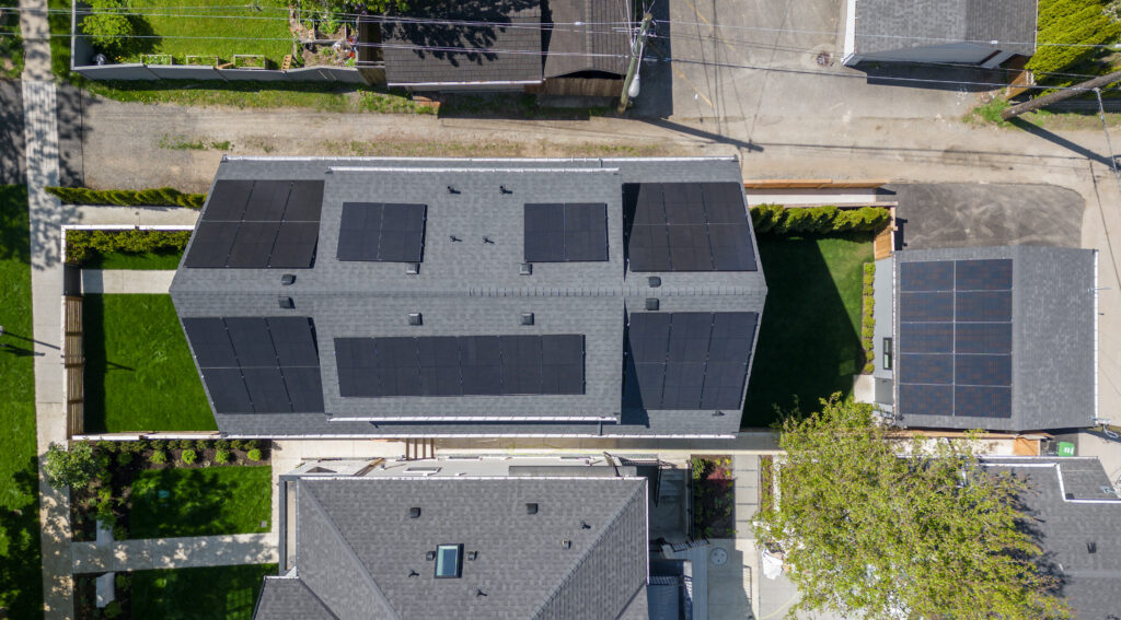 Drone photo directly overhead of solar panels on home and garage of Net Zero Duplex