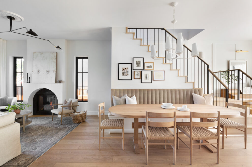 Wide image of livingroom, dining and stairs