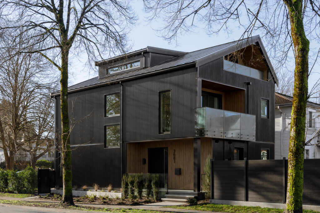 Exterior view of St. George Street, Vancouver. A custom-built modern residence featuring dark cladding, clean geometric lines, and thoughtful landscaping.